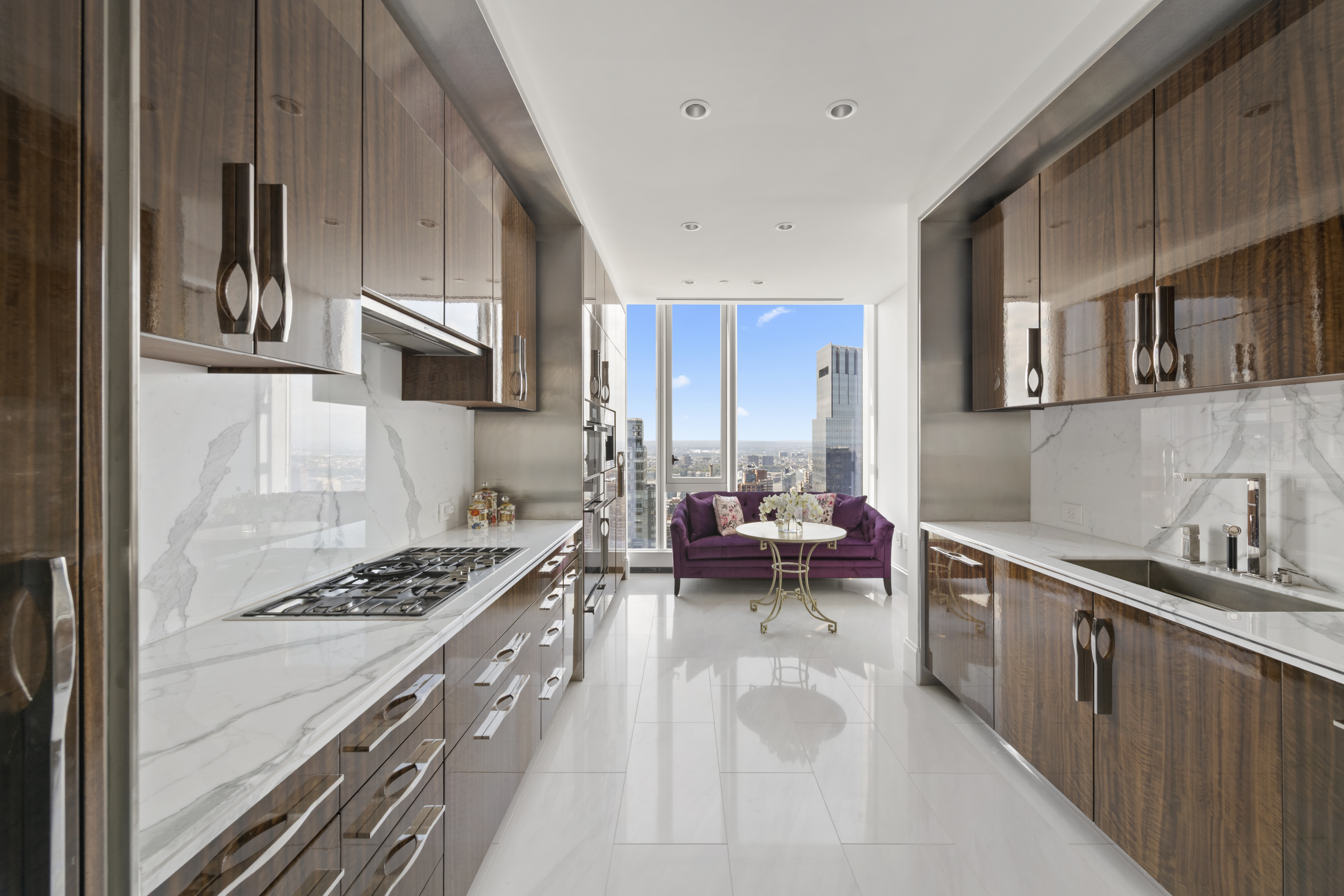 217 West 57th Street, Unit 58W Manhattan, NY 10019 - Photo 6 of 30 a kitchen with a stove a sink and cabinets