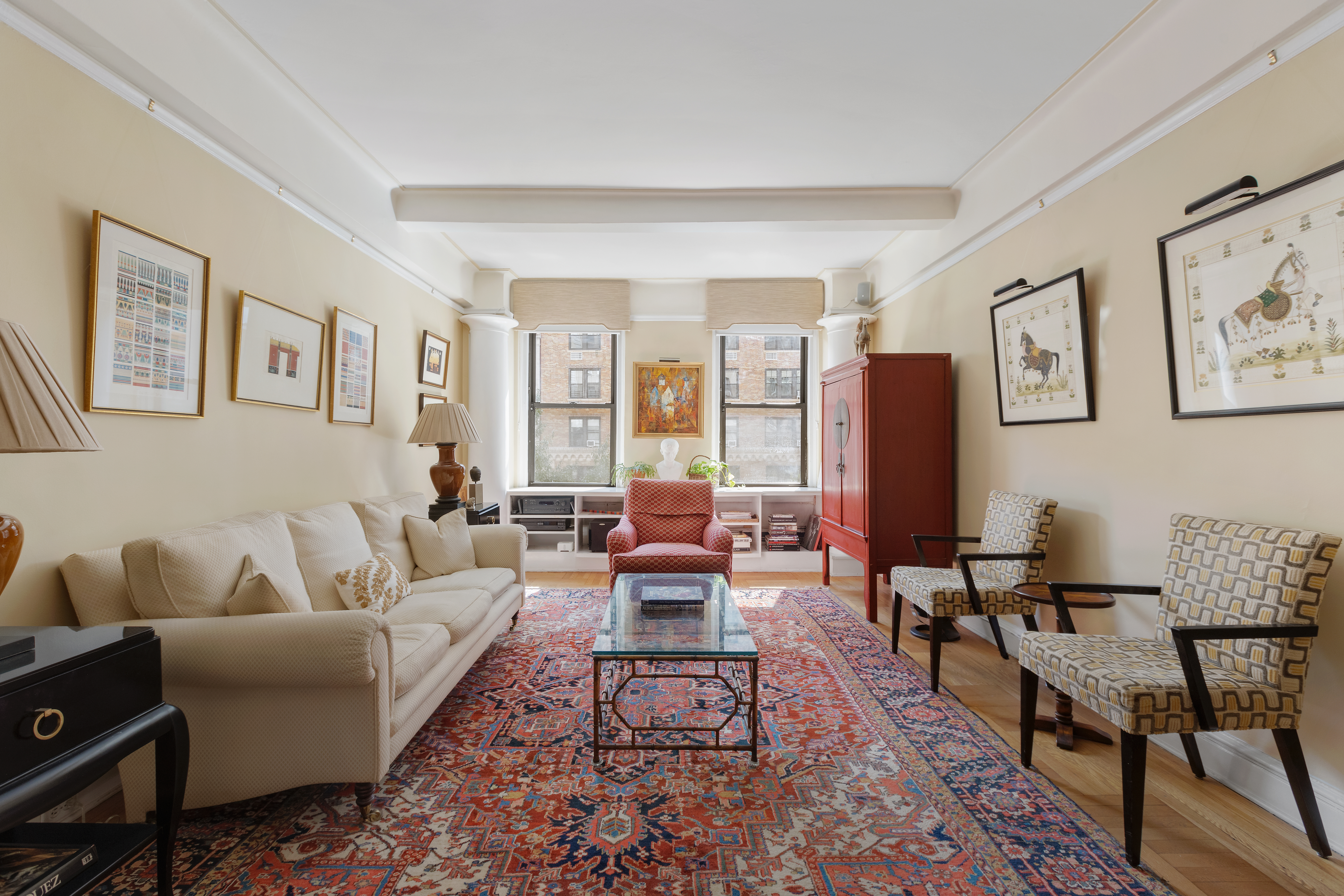 a living room with furniture wooden floor and a table