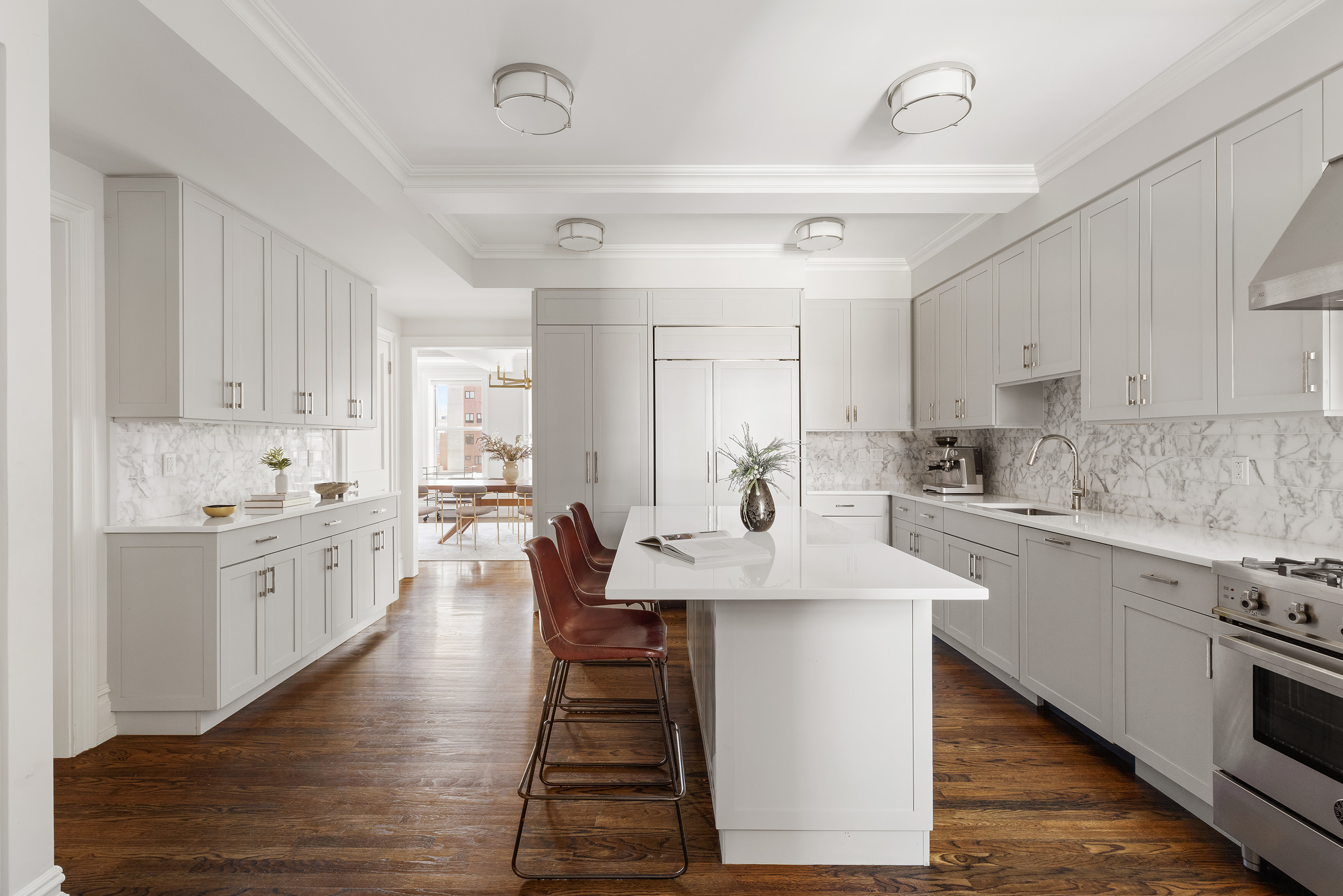 165 West 91st Street, Unit 9AB Manhattan, NY 10024 - Photo 5 of 24 a kitchen with sink stove and white cabinets with wooden floor