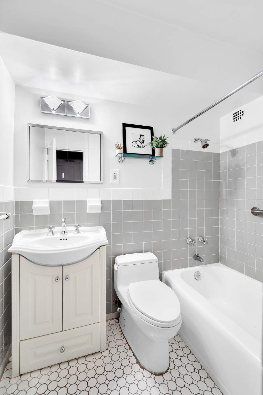 411 East 53rd Street, Unit 8C Manhattan, NY 10022 - Photo 7 of 10 a bathroom with a sink a toilet and shower
