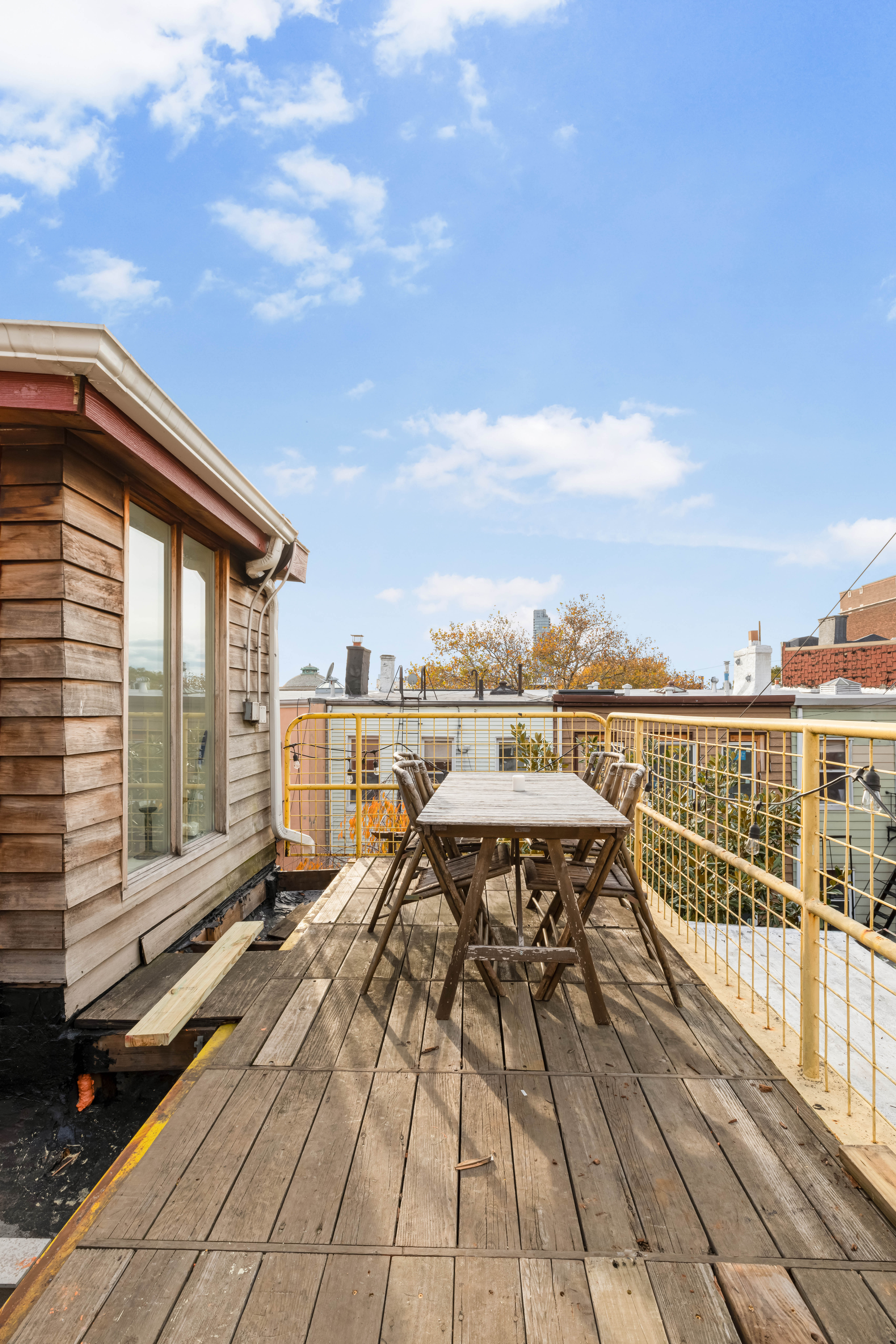 209 Calyer Street, Unit 2 Brooklyn, NY 11222 - Photo 17 of 17 a view of a terrace with wooden floor and city view