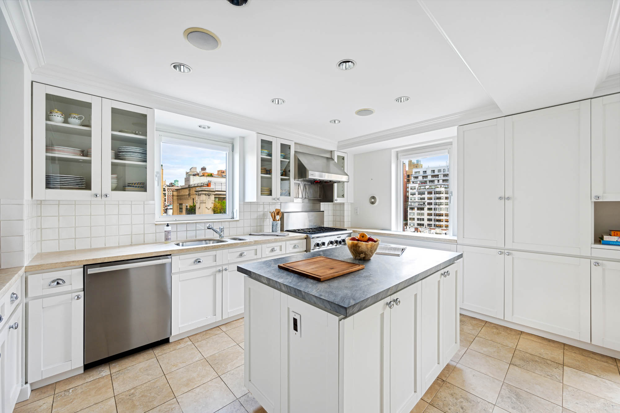 936 5th Avenue, Unit 10AB Manhattan, NY 10021 - Photo 12 of 37 a kitchen that has a sink and a stove in it