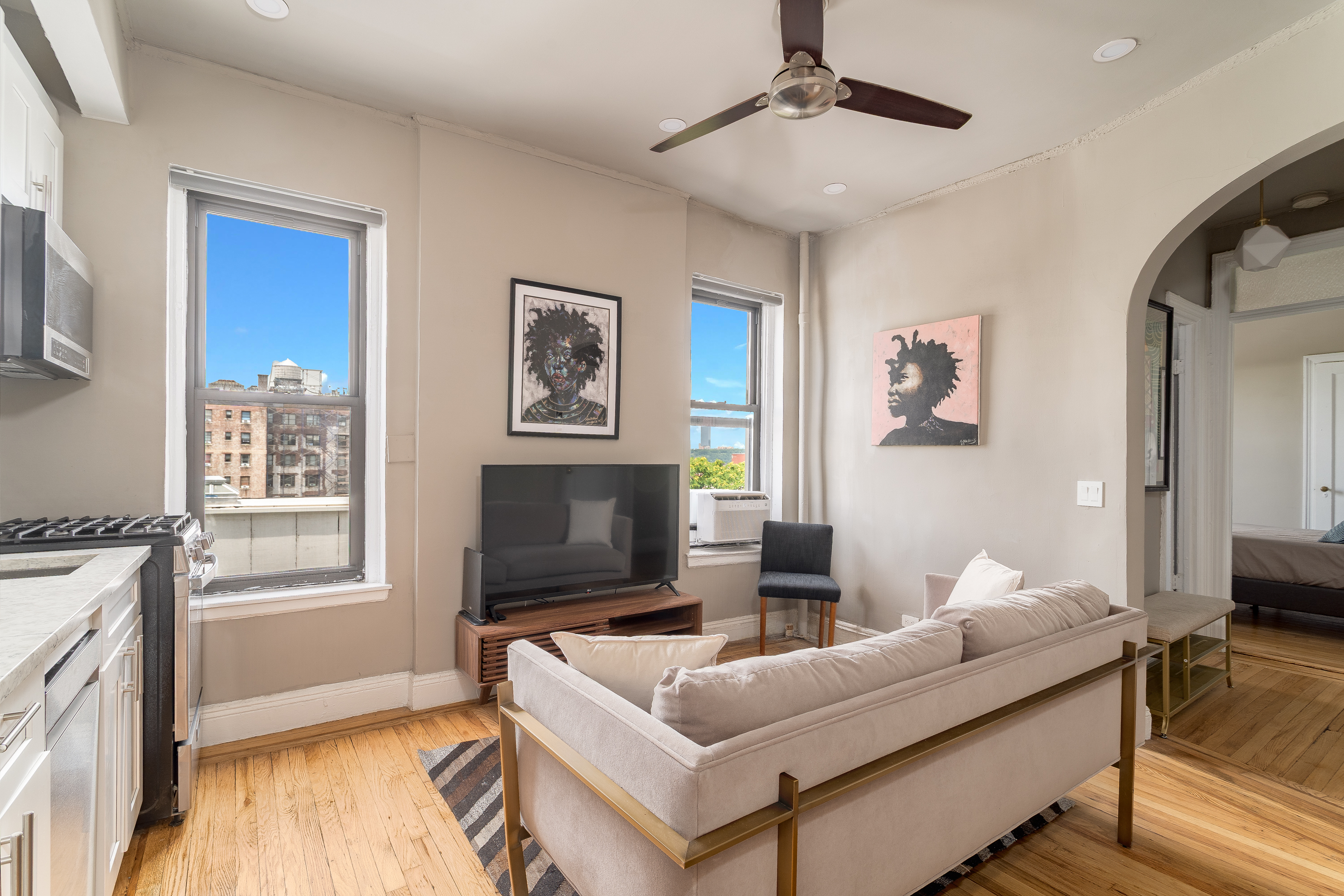 94 Hamilton Place, Unit 6E Manhattan, NY 10031 - Photo 2 of 16 a living room with furniture and a flat screen tv