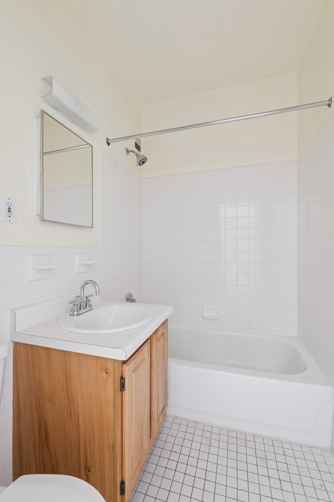 859 Riverside Drive, Unit 3 Manhattan, NY 10032 - Photo 4 of 7 a bathroom with a sink a mirror and a bathtub