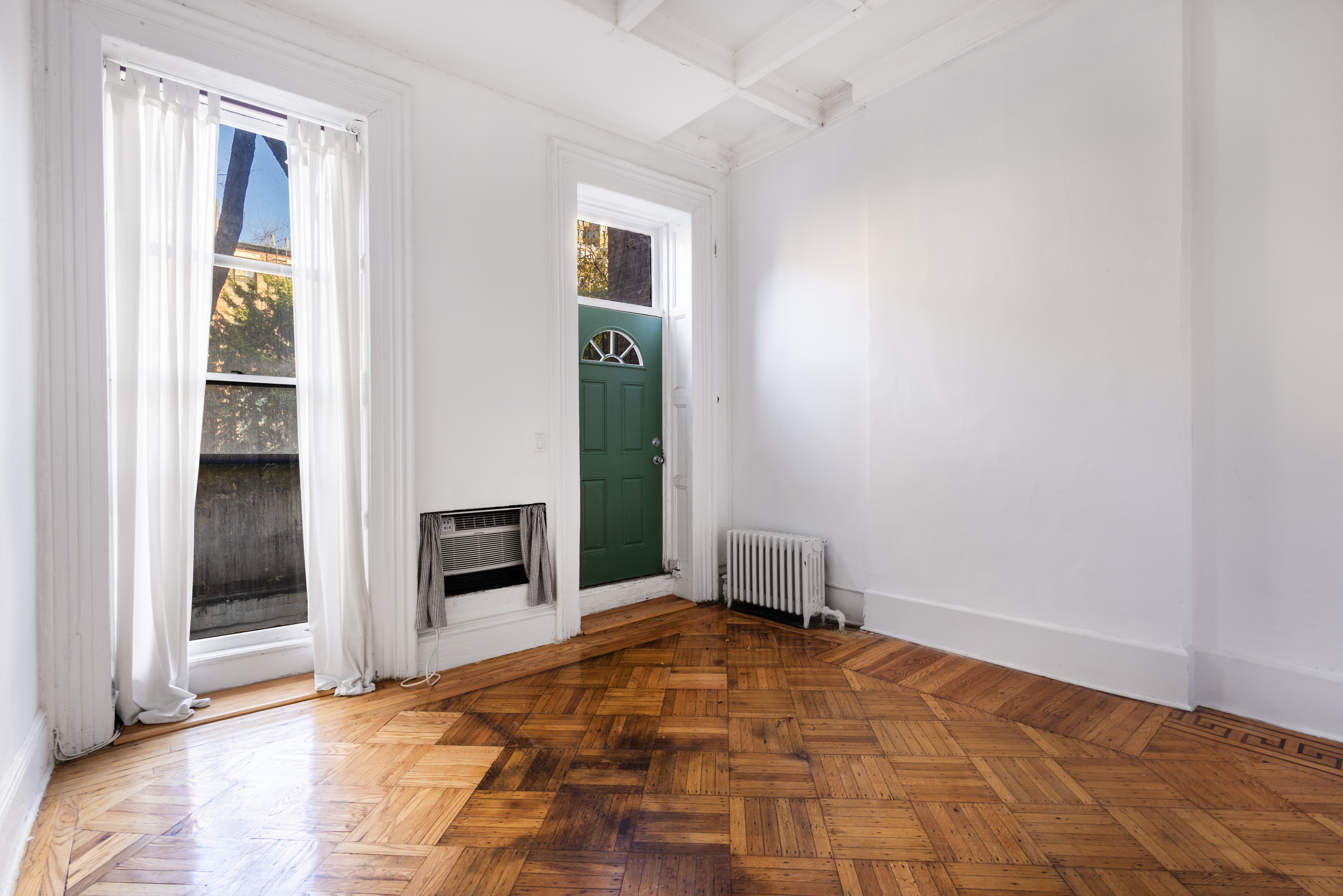 145 State Street, Unit 1 Brooklyn, NY 11201 - Photo 7 of 12 a view of an empty room with a fireplace and a window