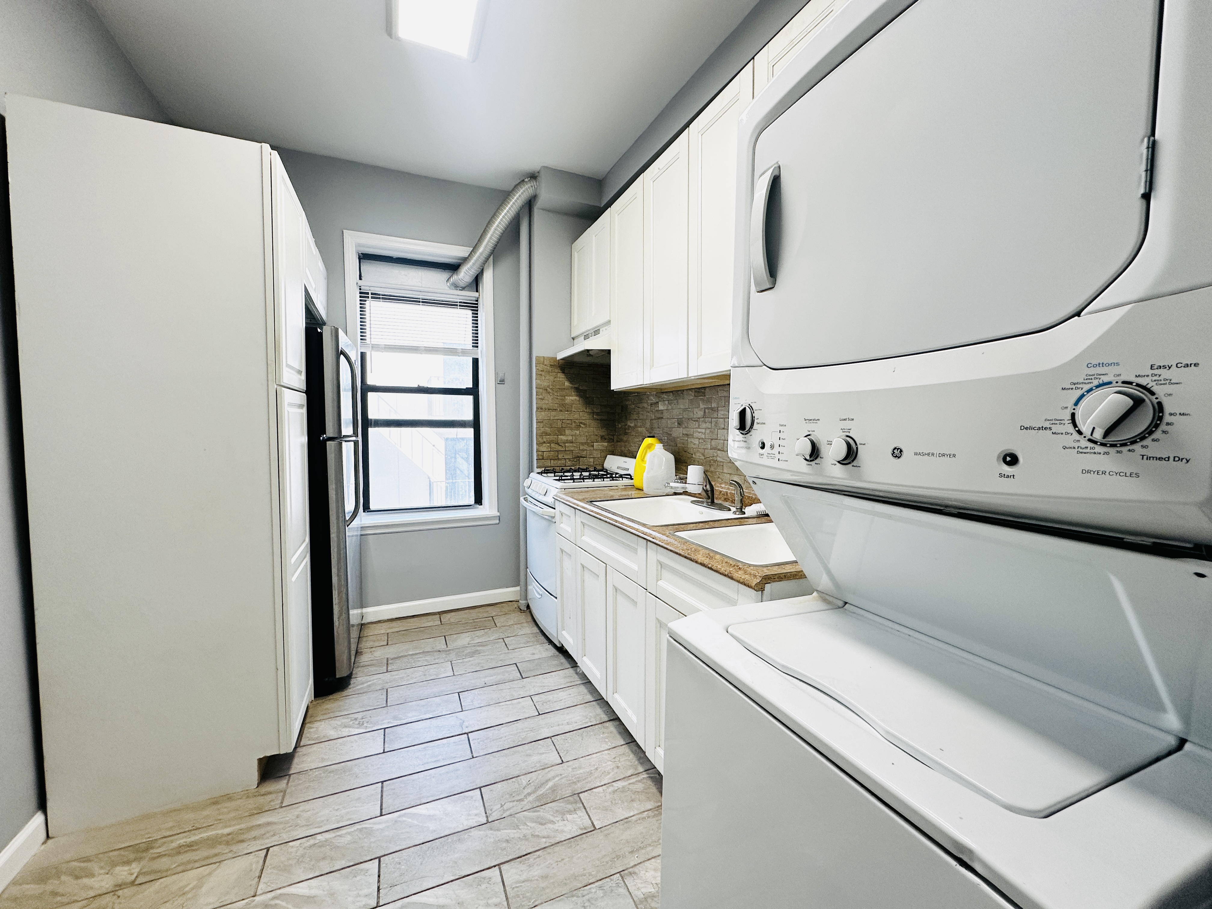 111 Lee Avenue, Unit 4B Brooklyn, NY 11211 - Photo 2 of 4 a kitchen with stainless steel appliances a refrigerator and a stove