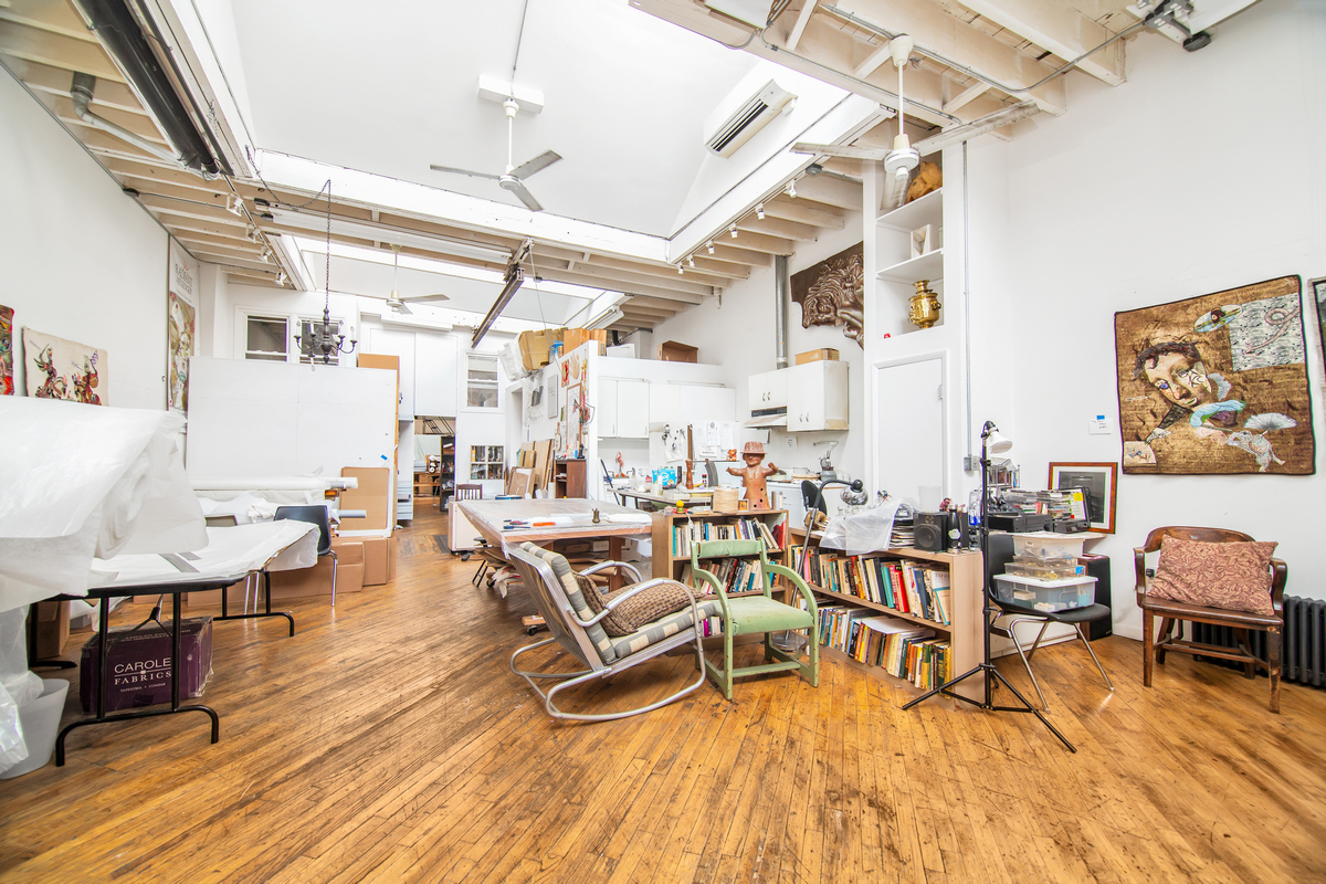 5-38 47th Road Queens, NY 11101 - Photo 2 of 14 a living room with lots of furniture and wooden floors