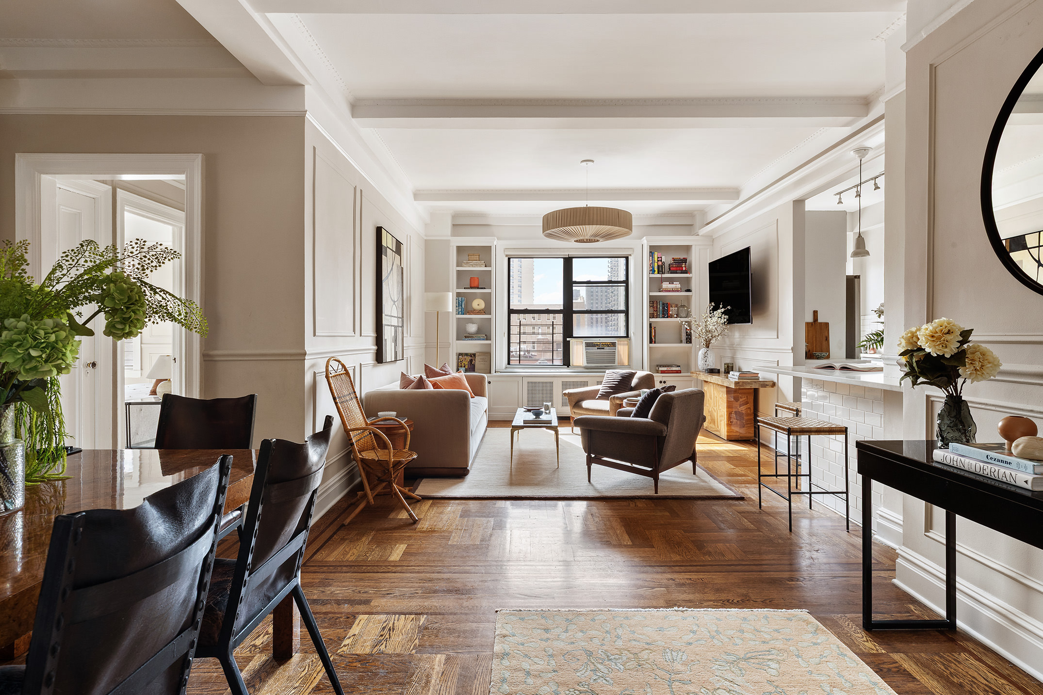 a living room with fireplace furniture and a large window