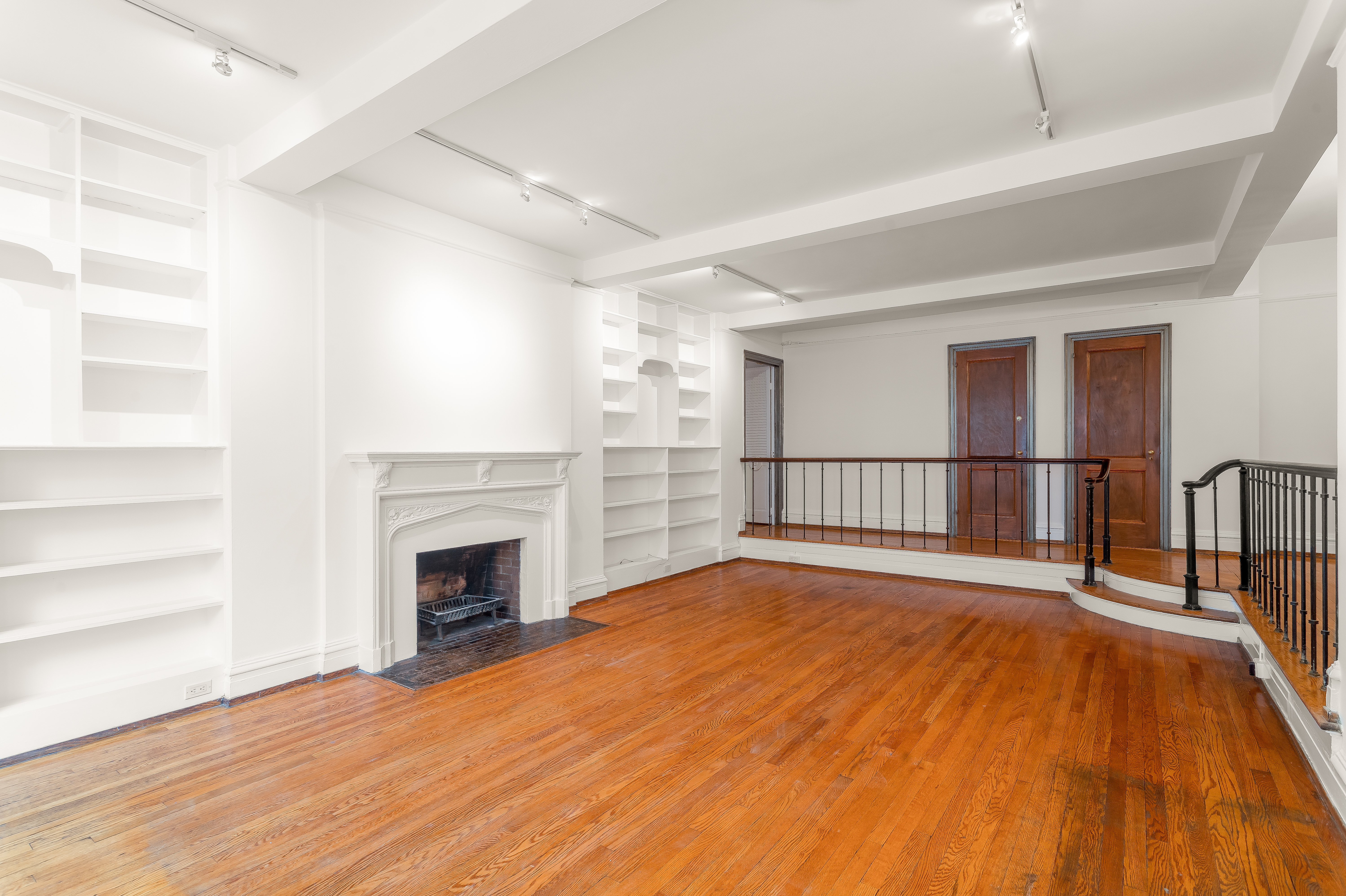 180 East 79th Street, Unit 5A Manhattan, NY 10075 - Photo 6 of 19 a view of a livingroom with wooden floor and a fireplace