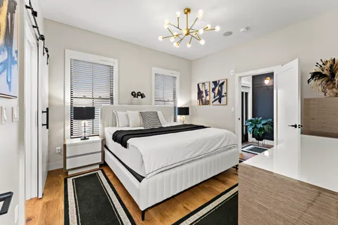 a bedroom with a bed and a chandelier