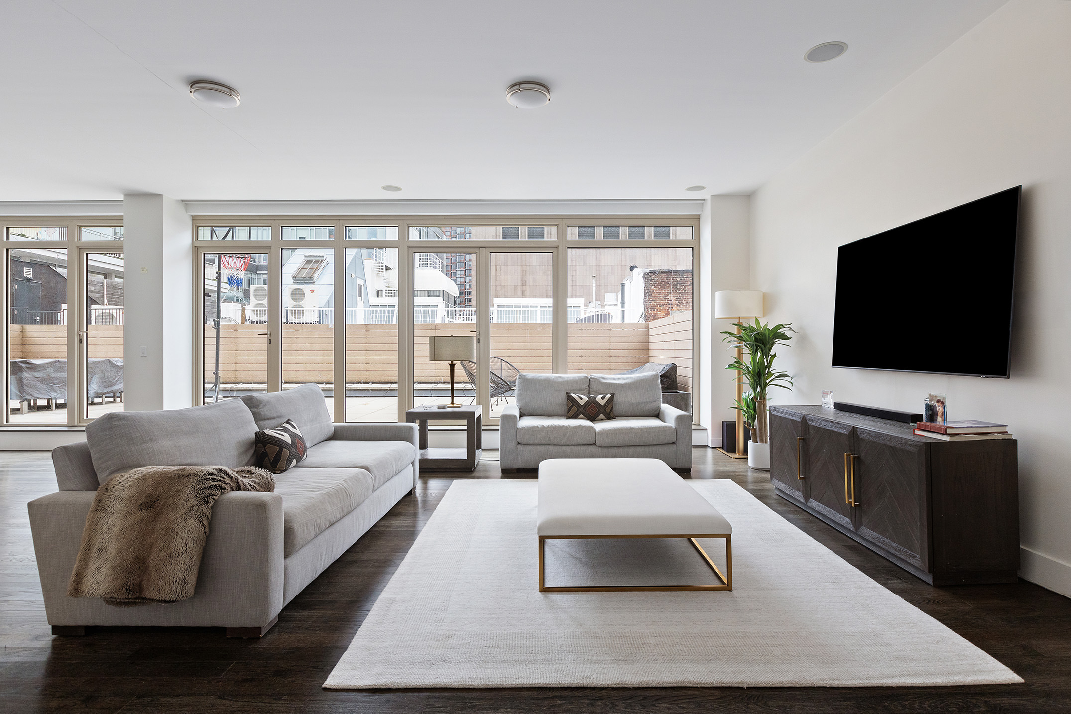 83 Franklin Street, Unit PH Manhattan, NY 10013 - Photo 2 of 13 a living room with furniture and a flat screen tv