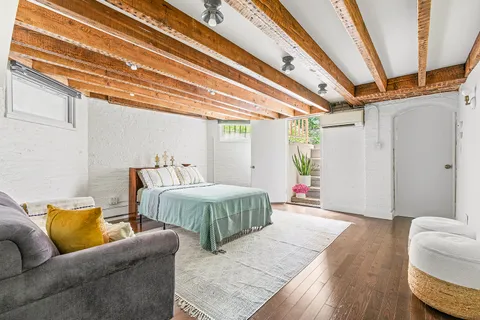 a bedroom with furniture and a wooden floor