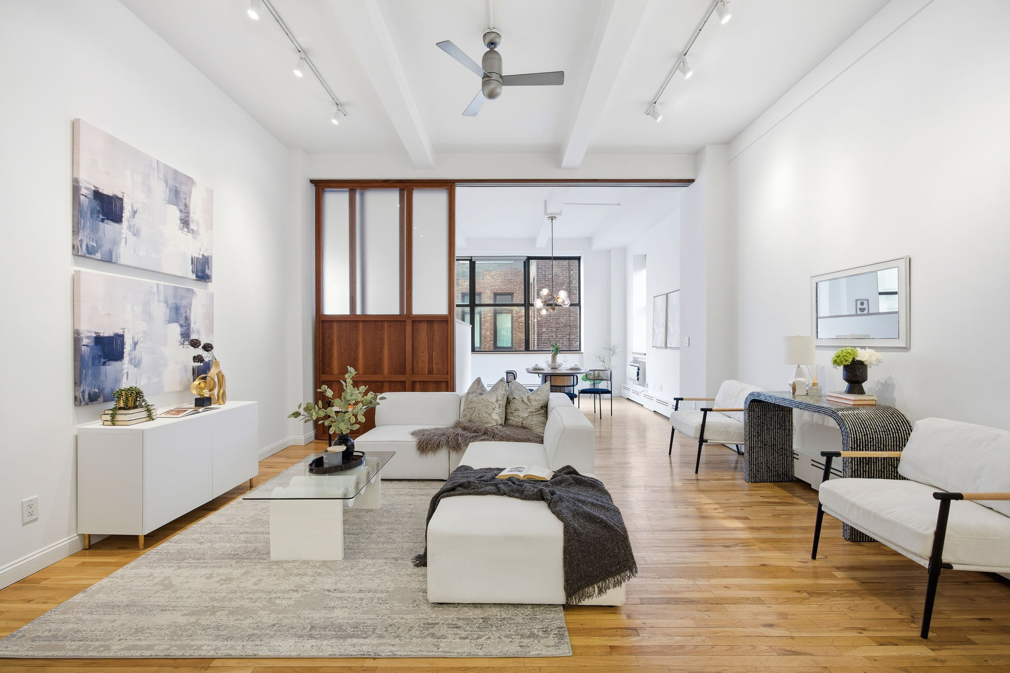 114 East 13th Street, Unit 6B Manhattan, NY 10003 - Photo 2 of 12 a living room with furniture and a window