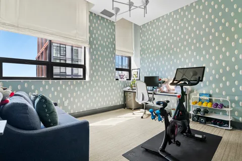a view of a livingroom with workspace and a window