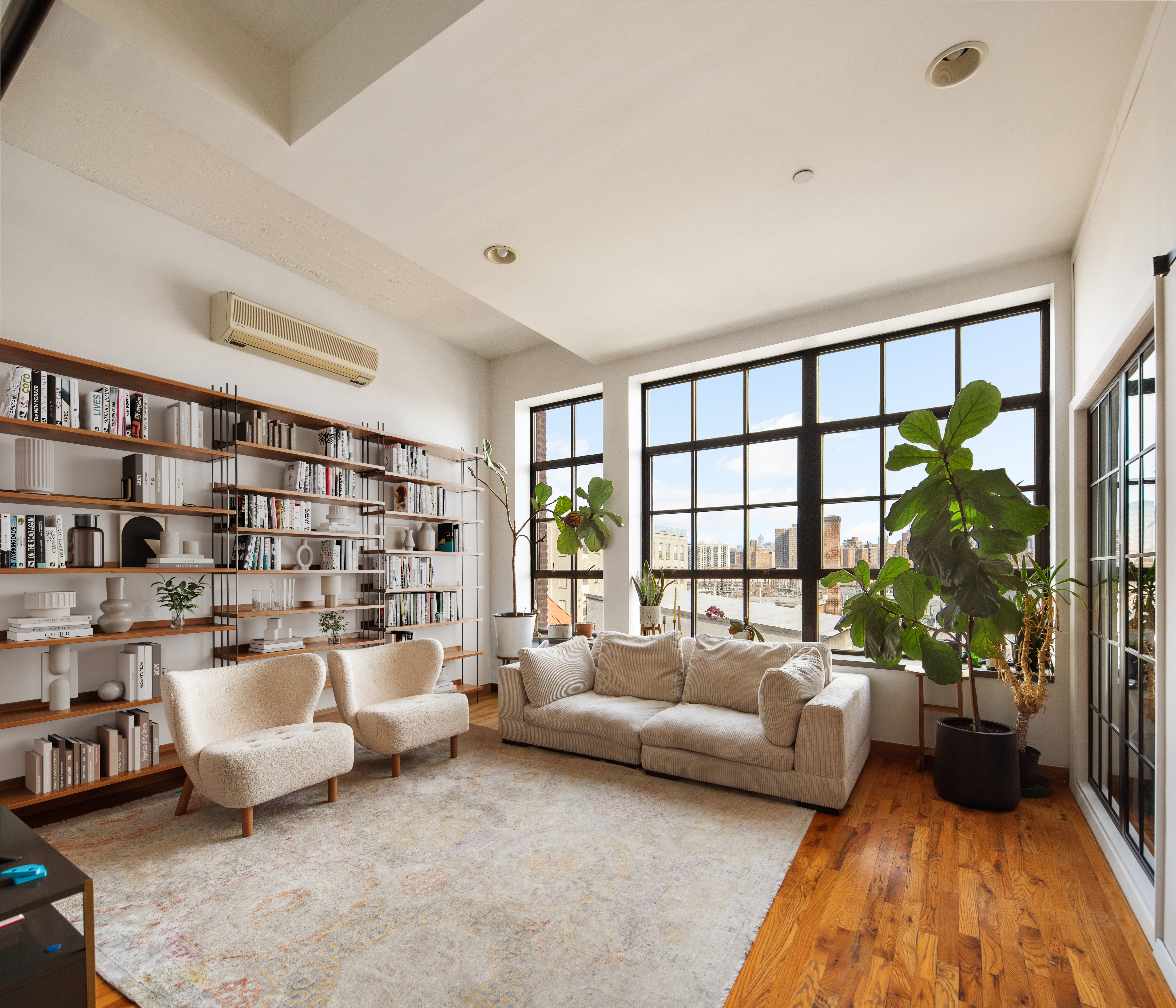 a living room with furniture and a large window with outer view