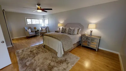 a spacious bedroom with a bed and a walk in closet