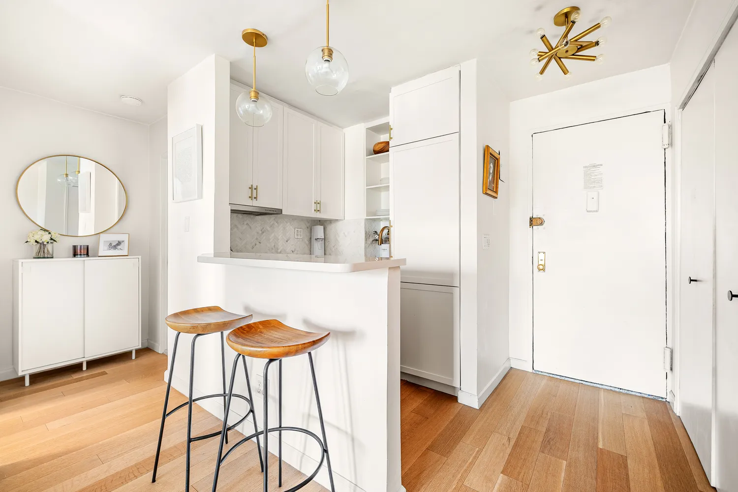 a bathroom with a sink a mirror a lamp and a shower