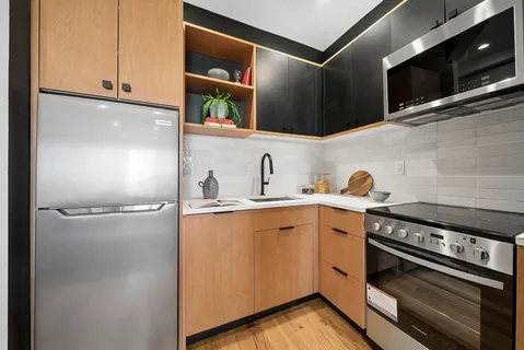 a kitchen with a refrigerator and a sink