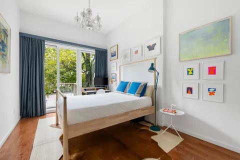 a bedroom with a bed and a large window