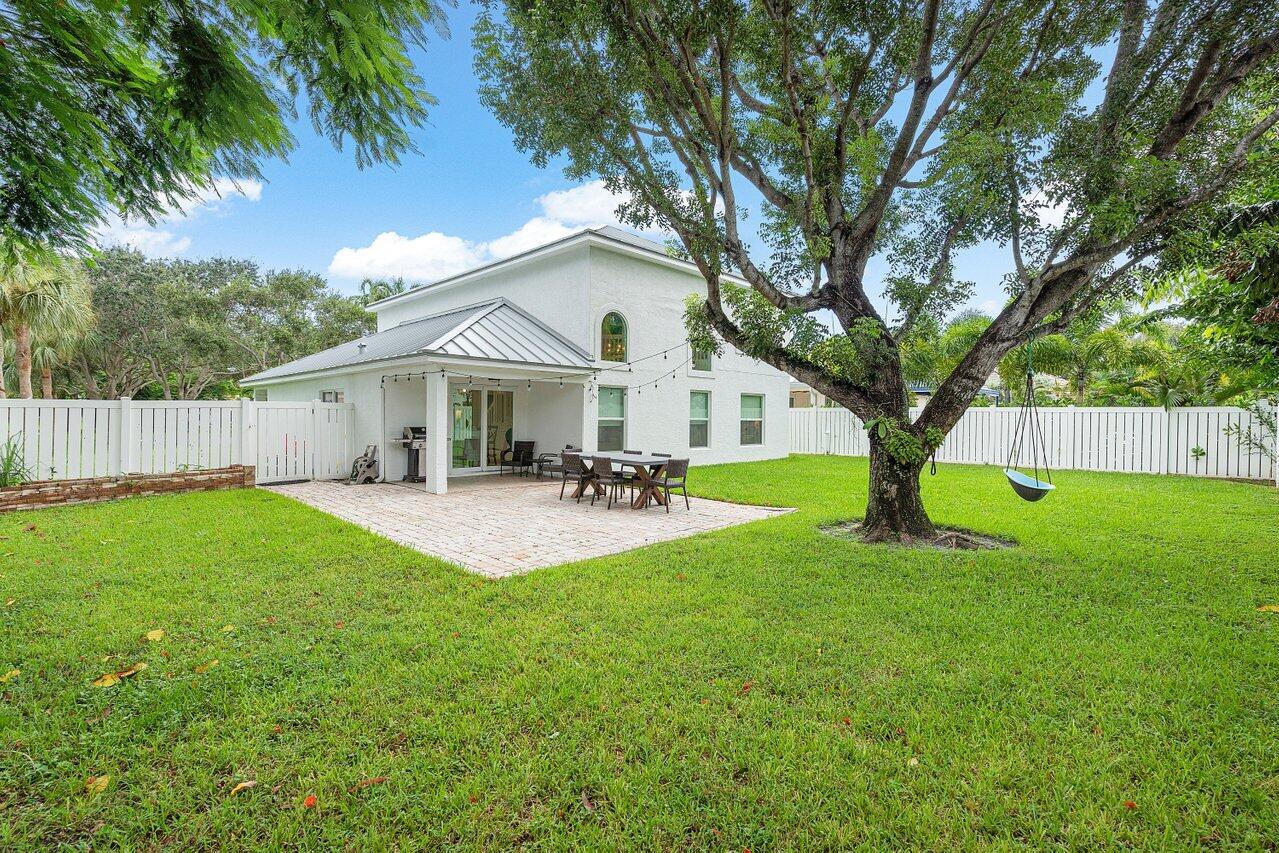 1182 Canoe Point Delray Beach, FL 33444 - Photo 29 of 46 a view of a house with backyard and a tree