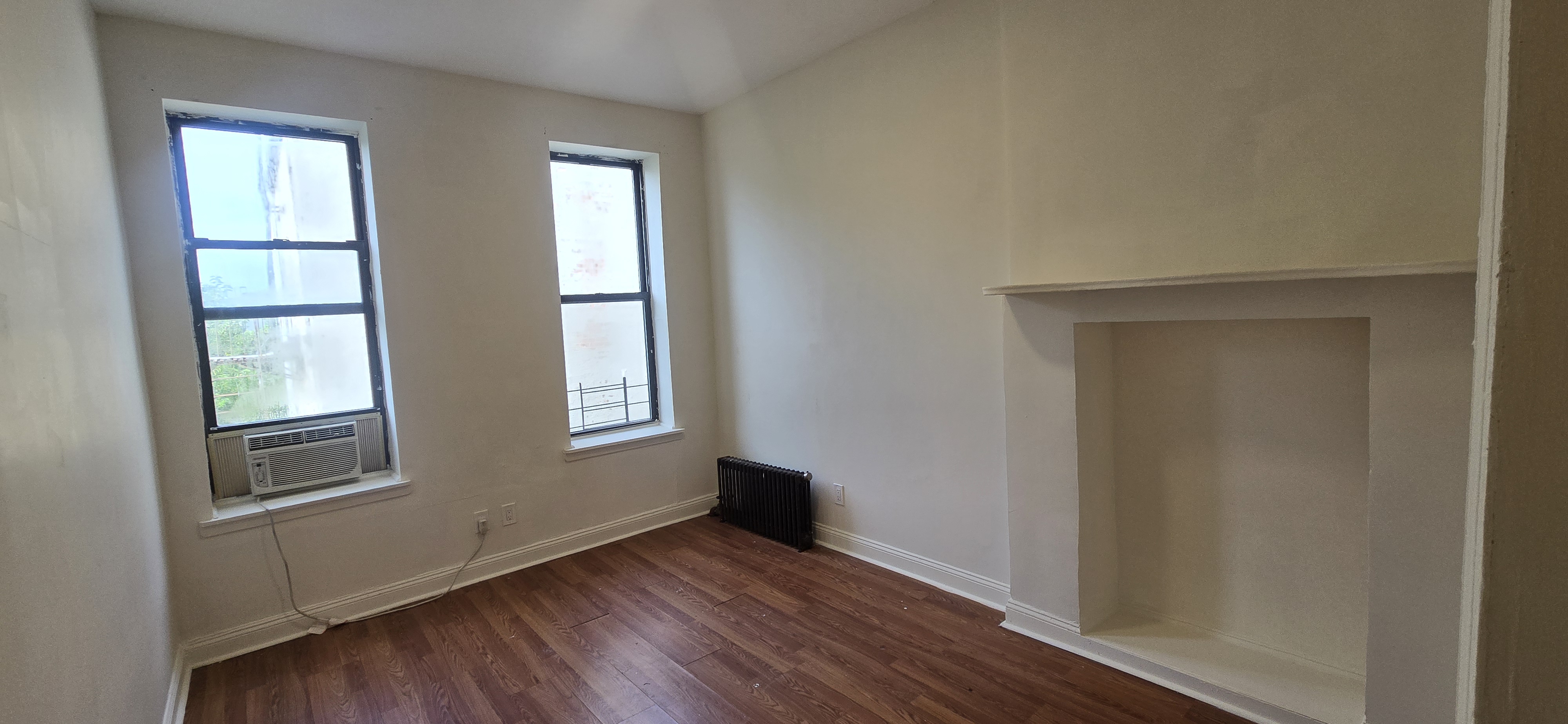 1501 Broadway, Unit 4 Brooklyn, NY 11221 - Photo 5 of 7 an empty room with wooden floor and windows