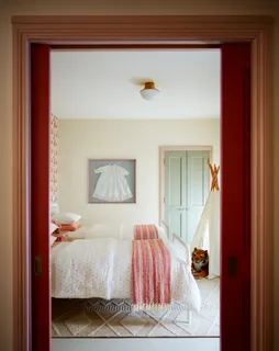 a bed sitting in a bedroom next to a large window