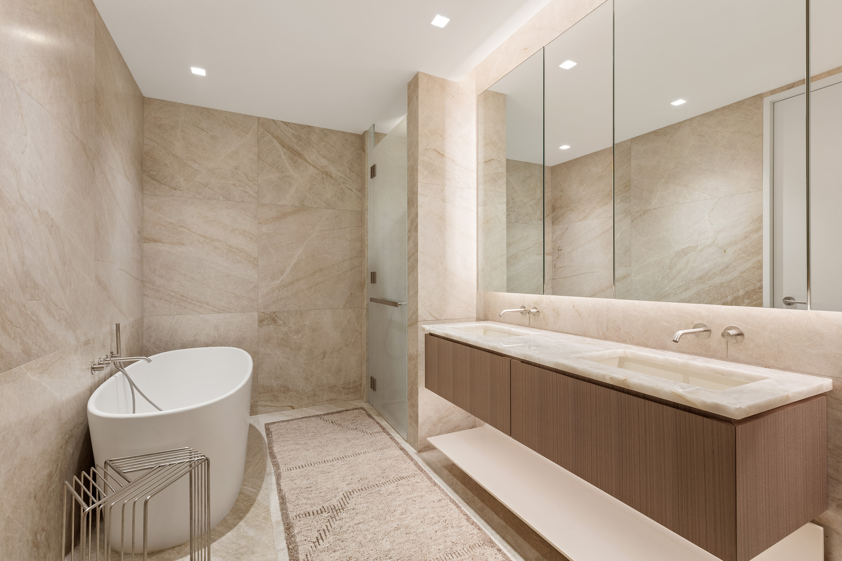 500 West 18th Street, Unit WEST 5E Manhattan, NY 10011 - Photo 12 of 15 a bathroom with a double vanity sink mirror and shower