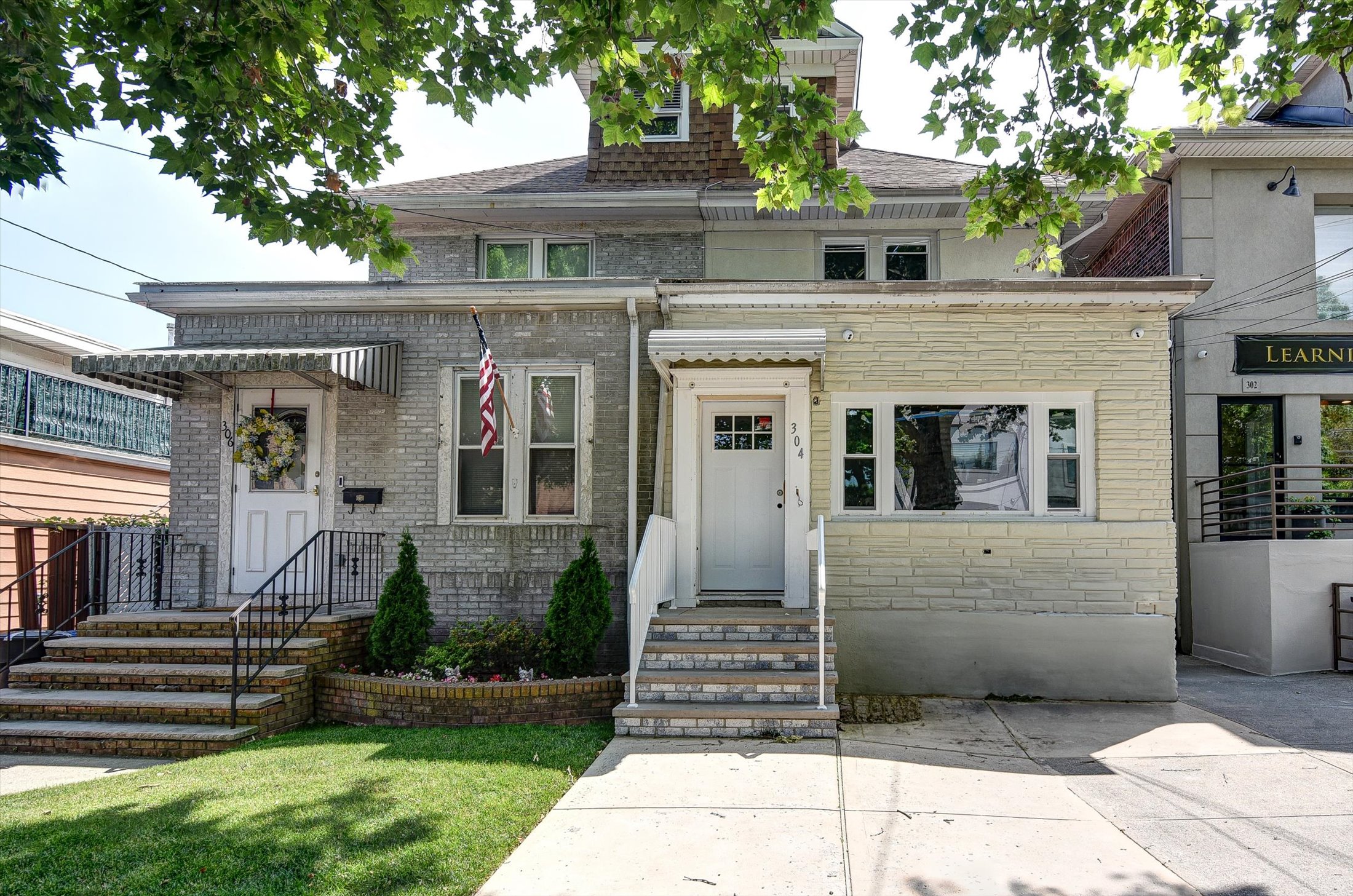 a front view of a house with a garden
