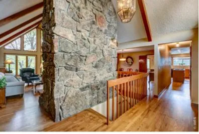 a living room with furniture a fireplace and a table