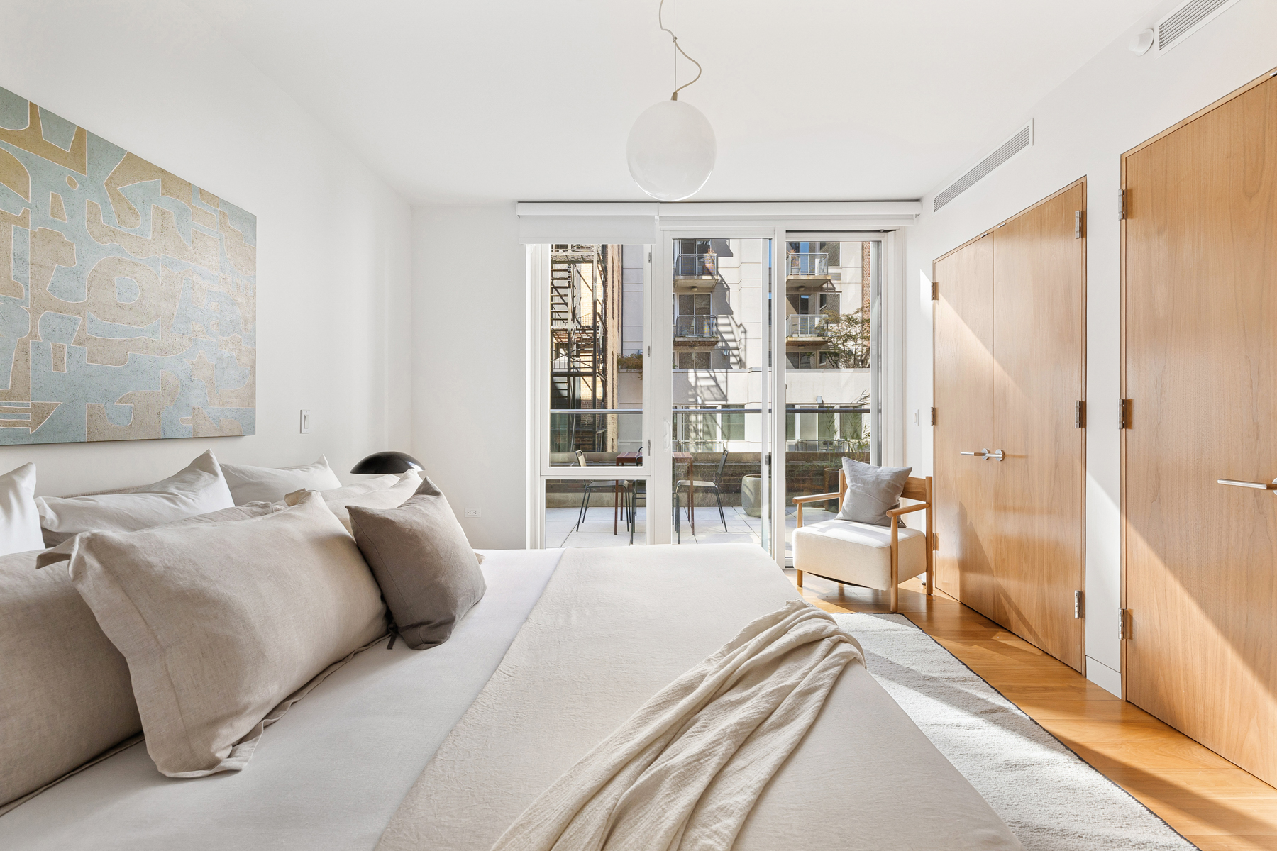 151 West 21st Street, Unit 10A Manhattan, NY 10011 - Photo 18 of 26 a large bedroom with a large bed and a large window