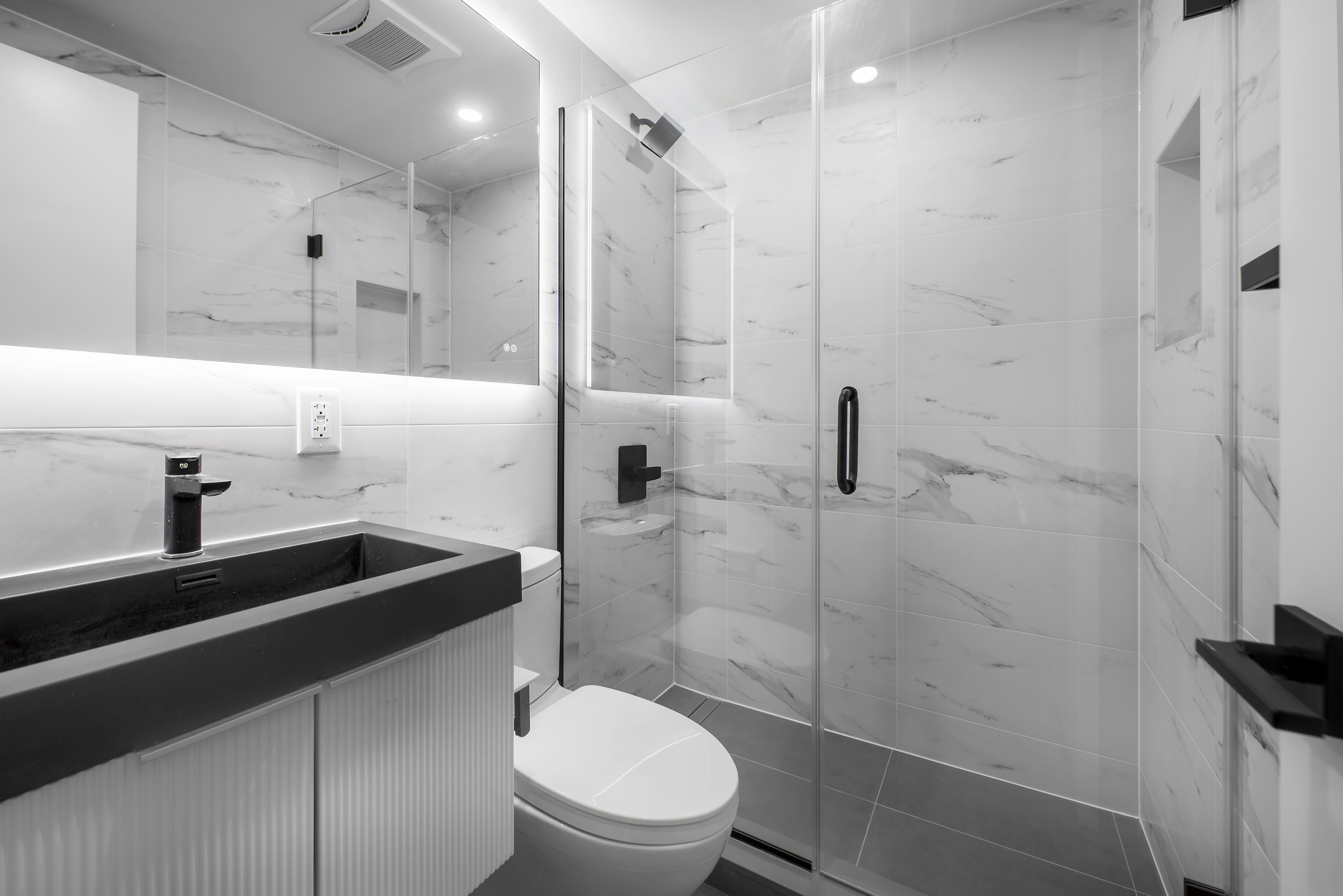 250 Union Avenue, Unit 3B Brooklyn, NY 11211 - Photo 7 of 7 a bathroom with a sink a toilet and shower