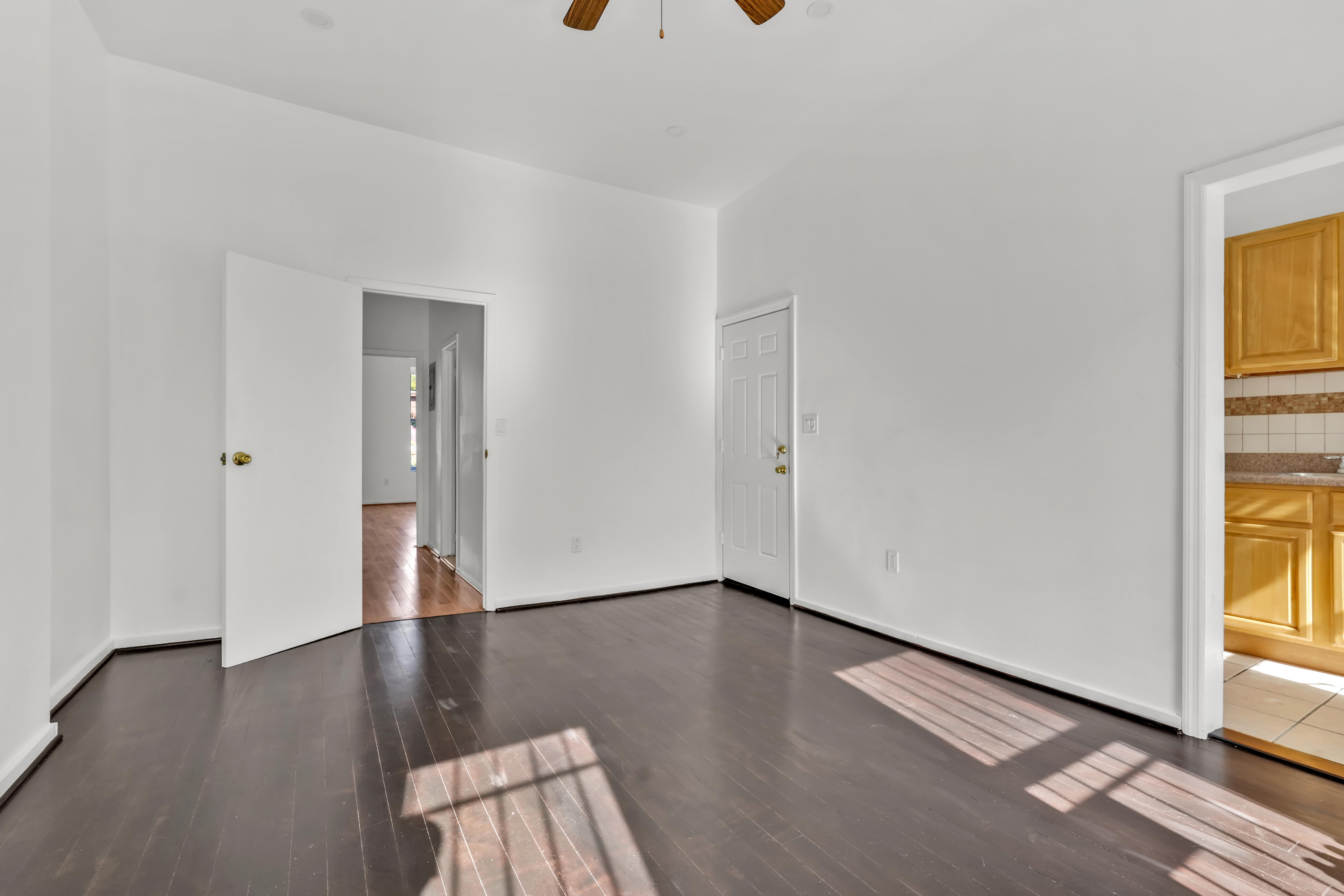 238 Vernon Avenue, Unit 2 Brooklyn, NY 11206 - Photo 9 of 21 an empty room with wooden floor and windows