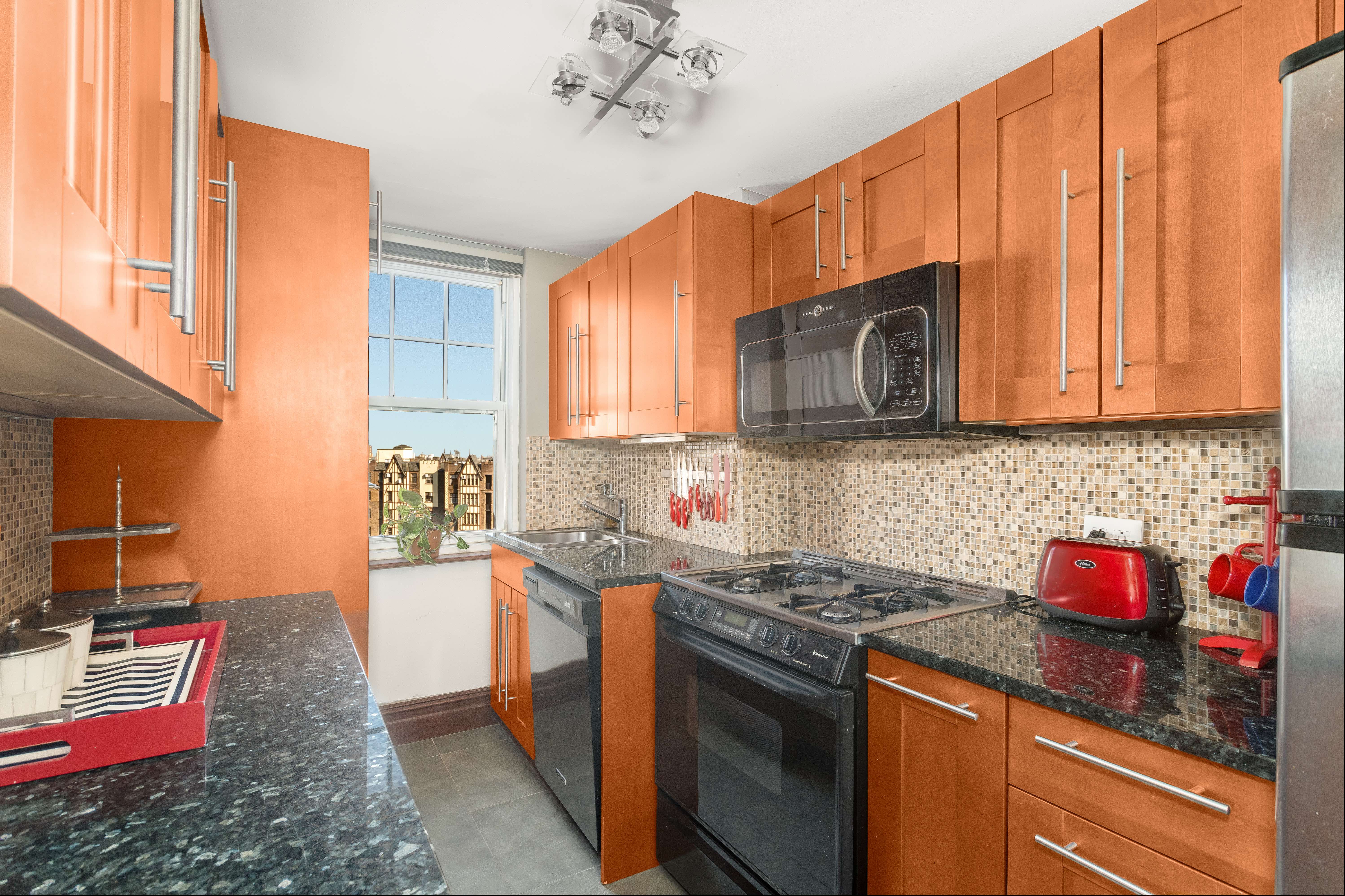 140 Cabrini Boulevard, Unit PH138 Manhattan, NY 10033 - Photo 7 of 30 a kitchen with stainless steel appliances granite countertop a stove a sink and a microwave