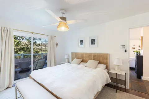 a bedroom with a bed and a large window