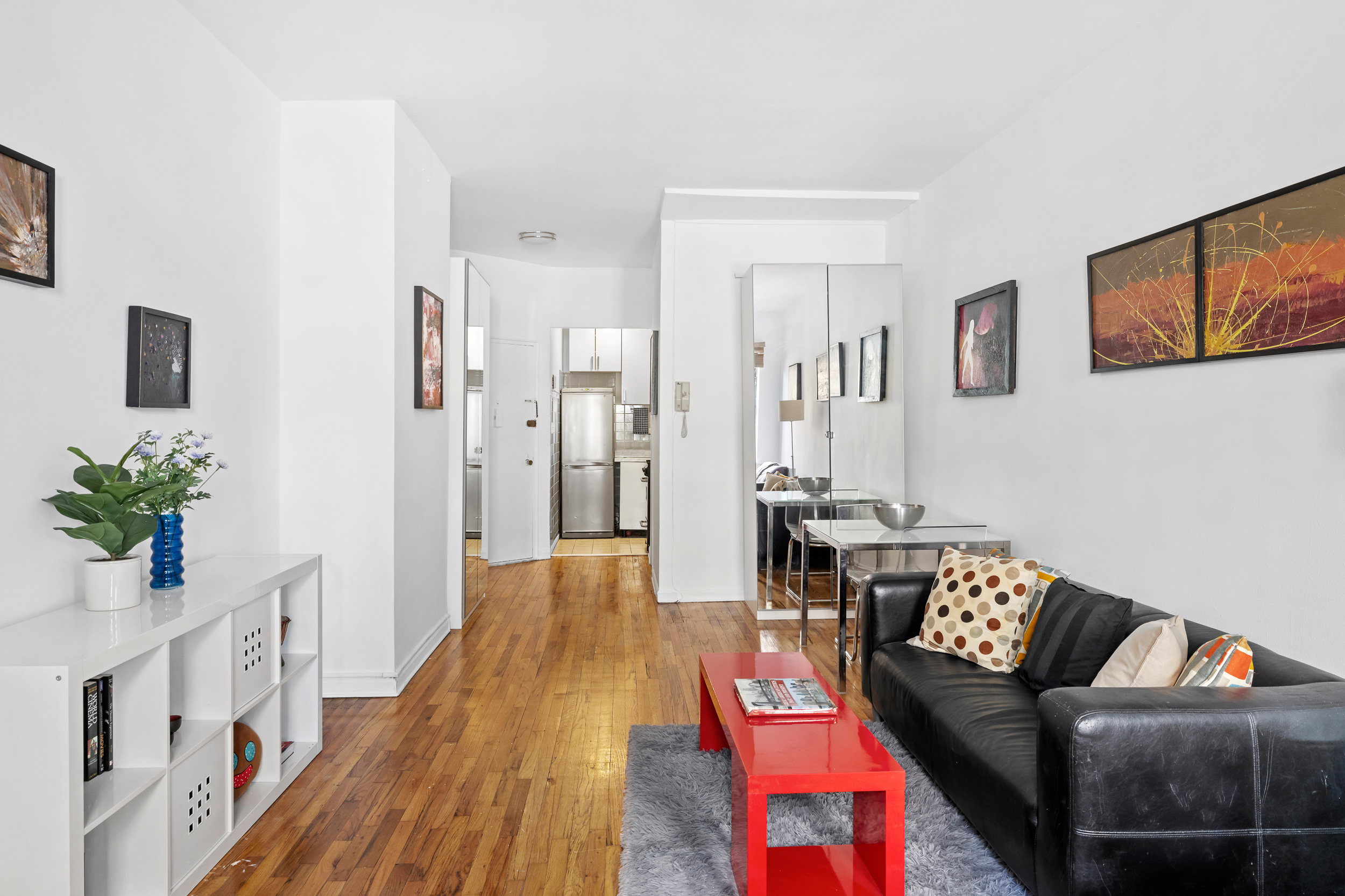 205 East 89th Street, Unit C4 Manhattan, NY 10128 - Photo 4 of 7 a living room with furniture and wooden floor