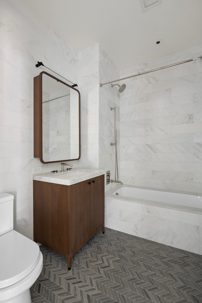 115 York Street, Unit 4J Brooklyn, NY 11201 - Photo 8 of 9 a bathroom with a toilet a bath tub and a shower