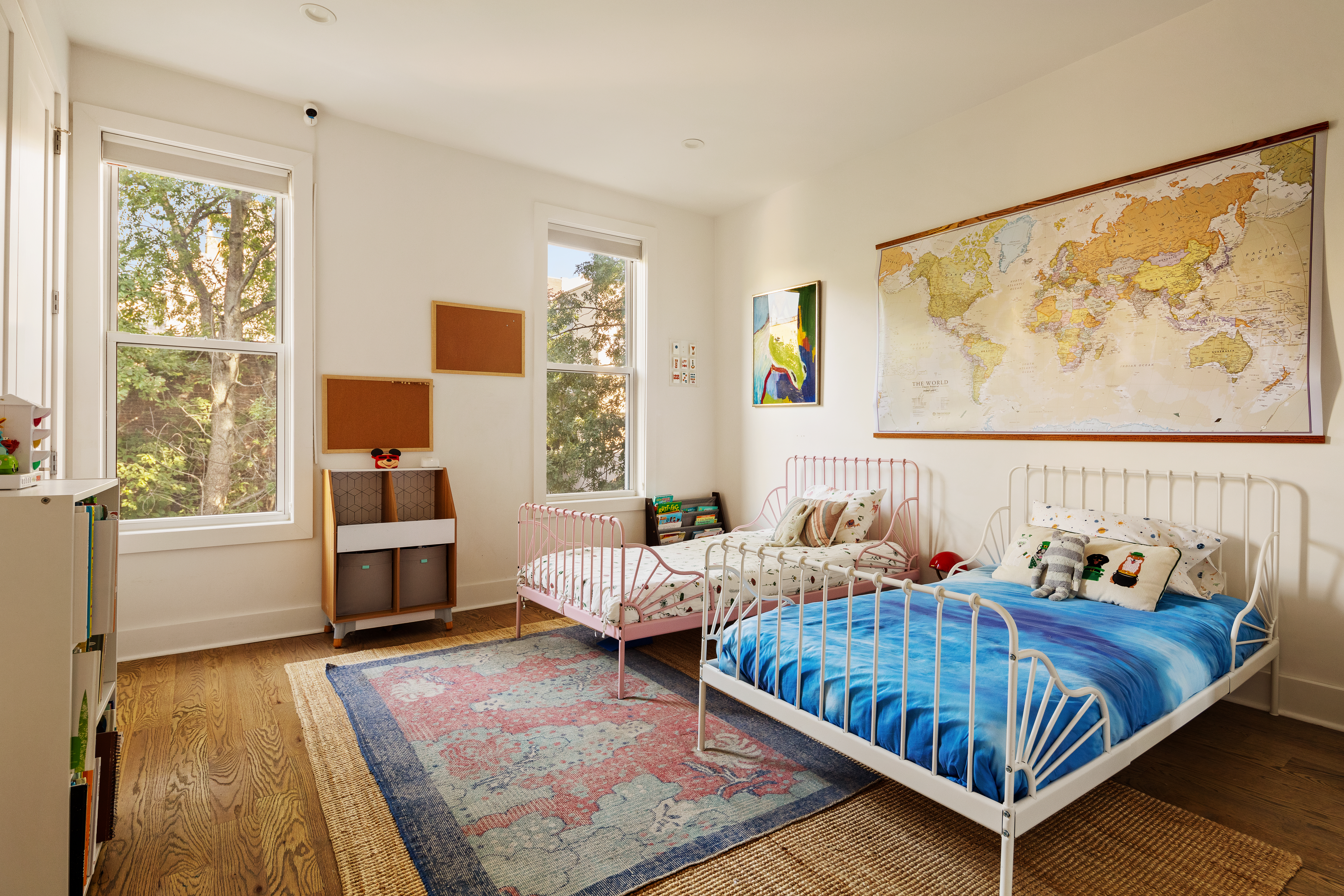 197 Madison Street Brooklyn, NY 11216 - Photo 12 of 19 a bedroom with two beds and a large window