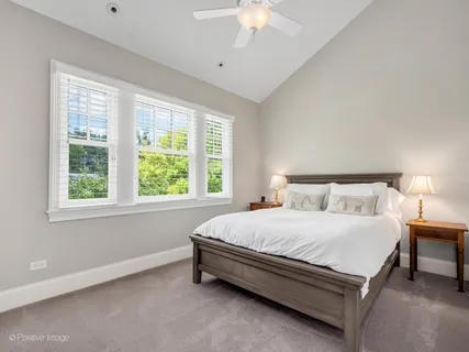 a bedroom with furniture and a large window