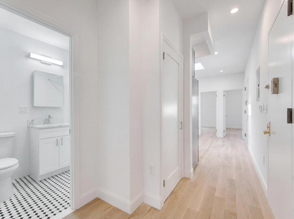 231 East 60th Street, Unit 5 Manhattan, NY 10022 - Photo 8 of 11 a bathroom with a sink and a mirror