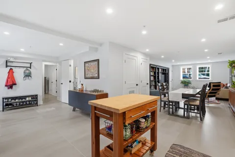 a living room with furniture a table and chairs