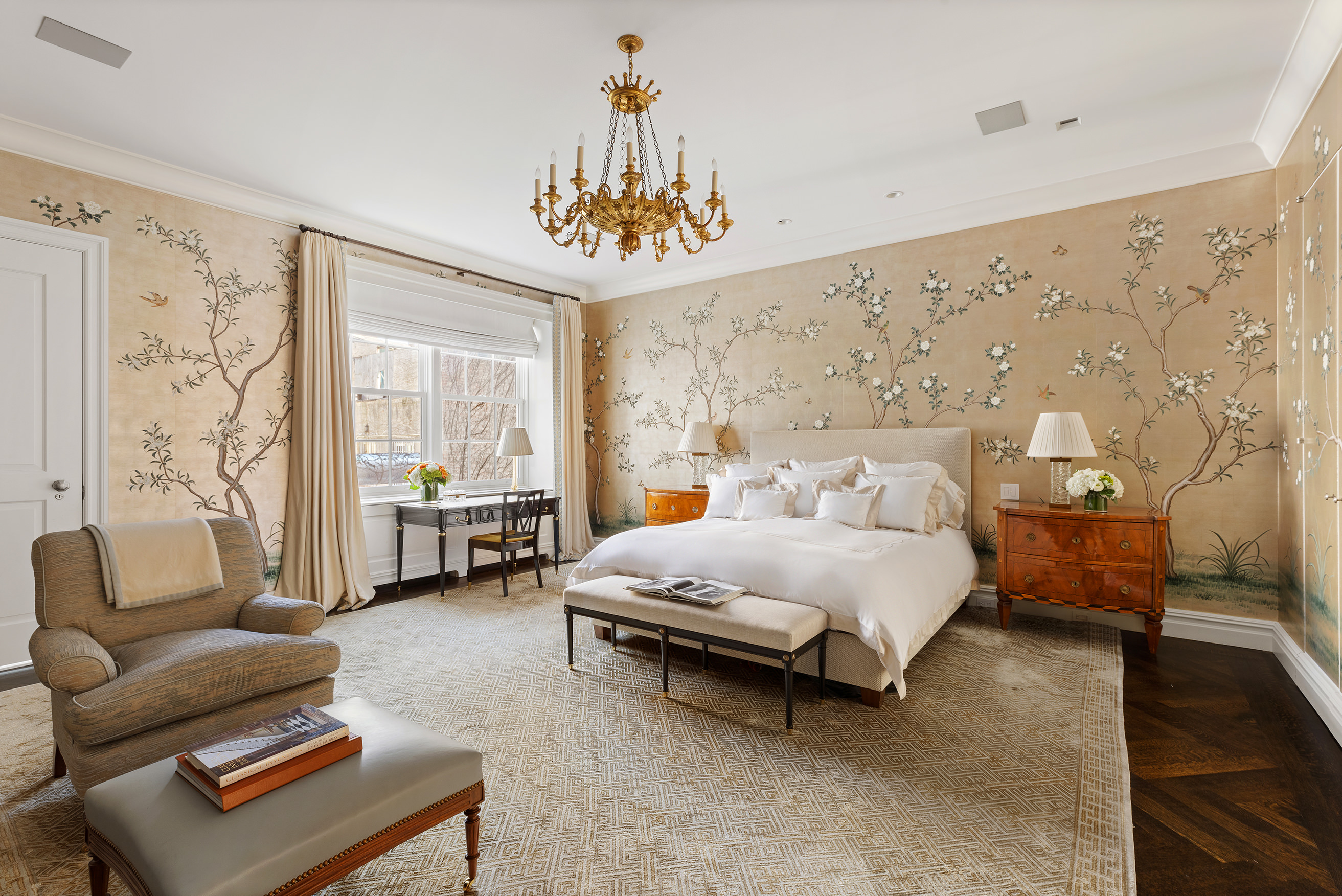 127 East 73rd Street Manhattan, NY 10021 - Photo 24 of 40 a spacious bedroom with a bed couch chandelier and a window