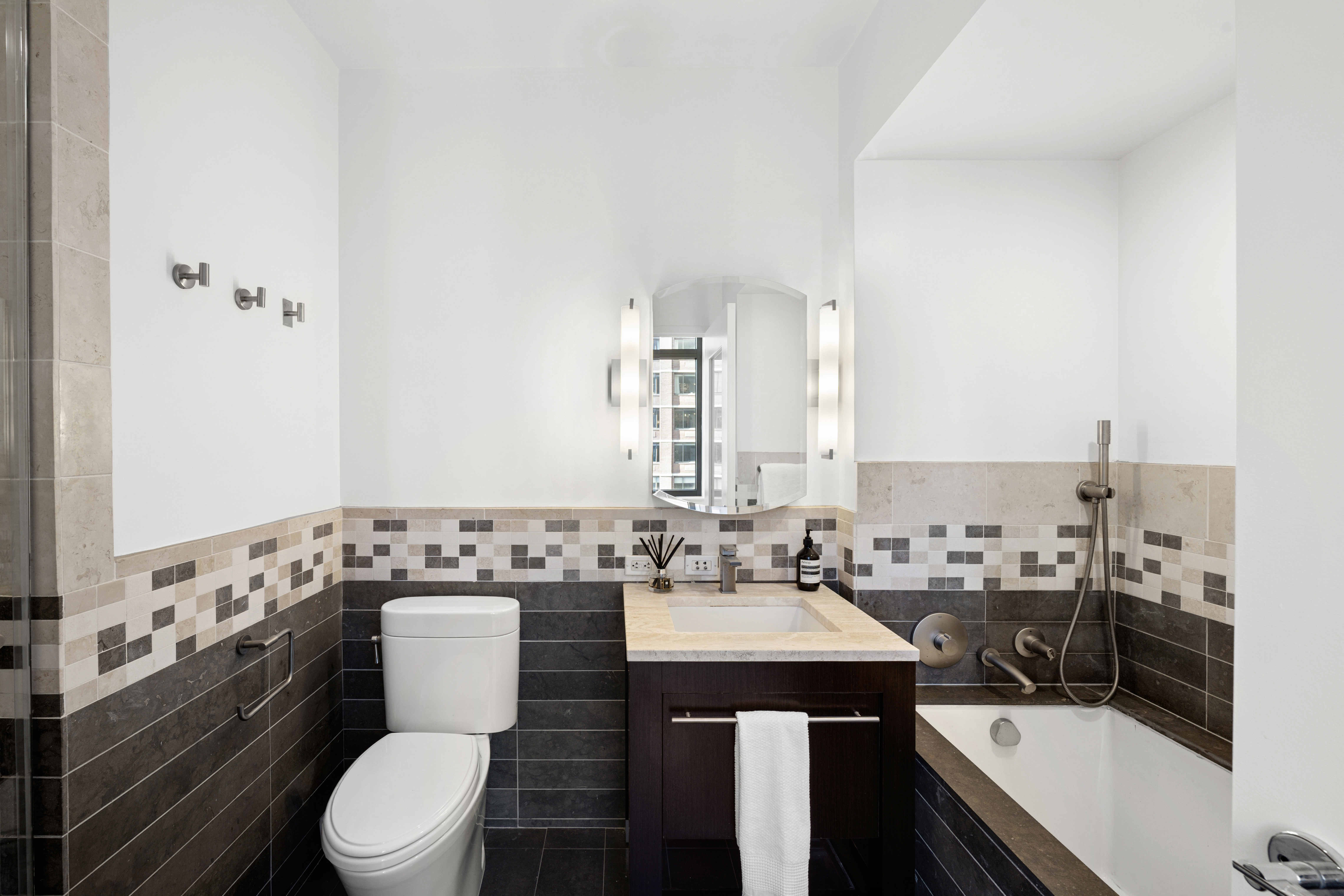 101 West 24th Street, Unit 23E Manhattan, NY 10011 - Photo 10 of 23 a bathroom with a sink a toilet and shower