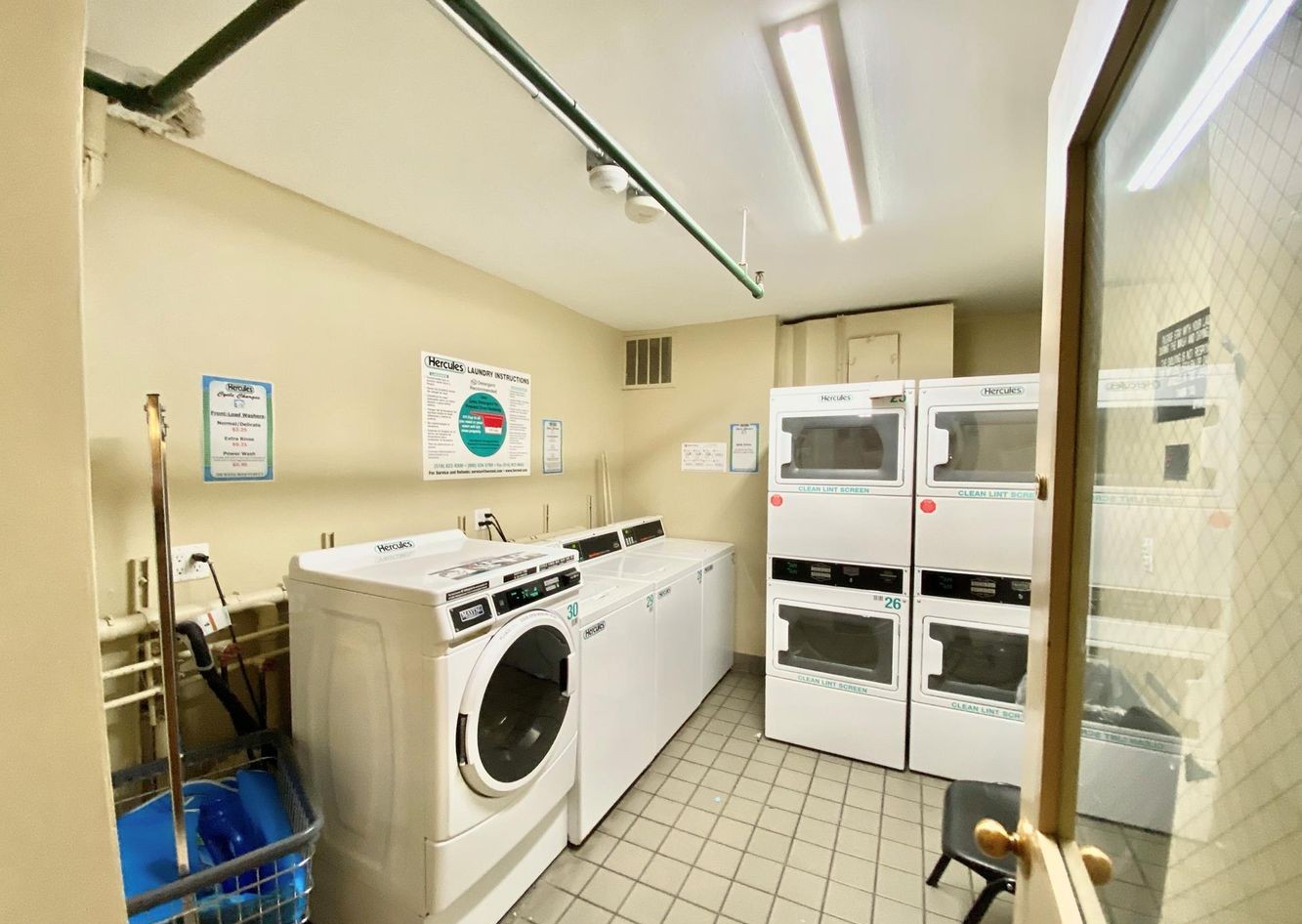 350 West 50th Street, Unit 3LL Manhattan, NY 10019 - Photo 13 of 15 a utility room with dryer and washer
