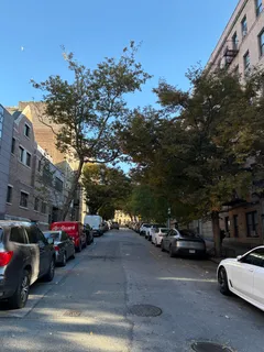 a view of street with parked cars