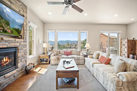 a living room with fireplace furniture and a wooden floor