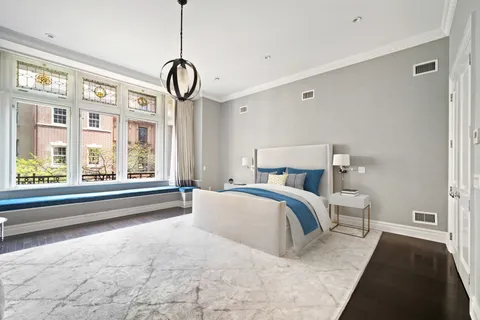 a spacious bedroom with a large bed and a window