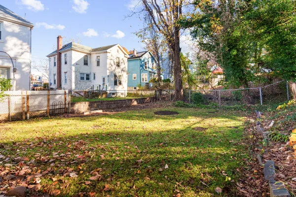 a view of a swimming pool with a patio and a yard