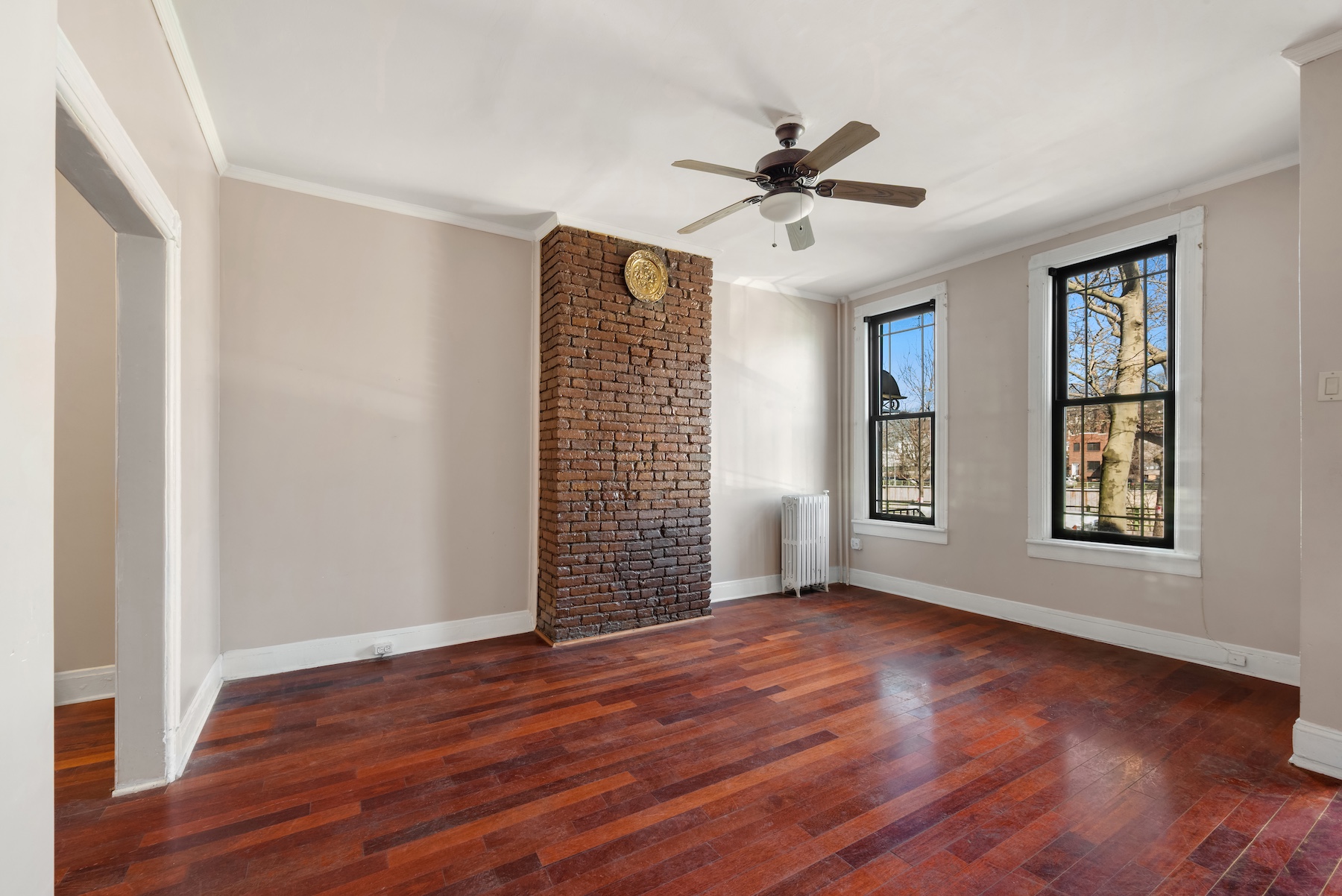 396 19th Street Brooklyn, NY 11215 - Photo 4 of 17 a view of an empty room with wooden floor and a window