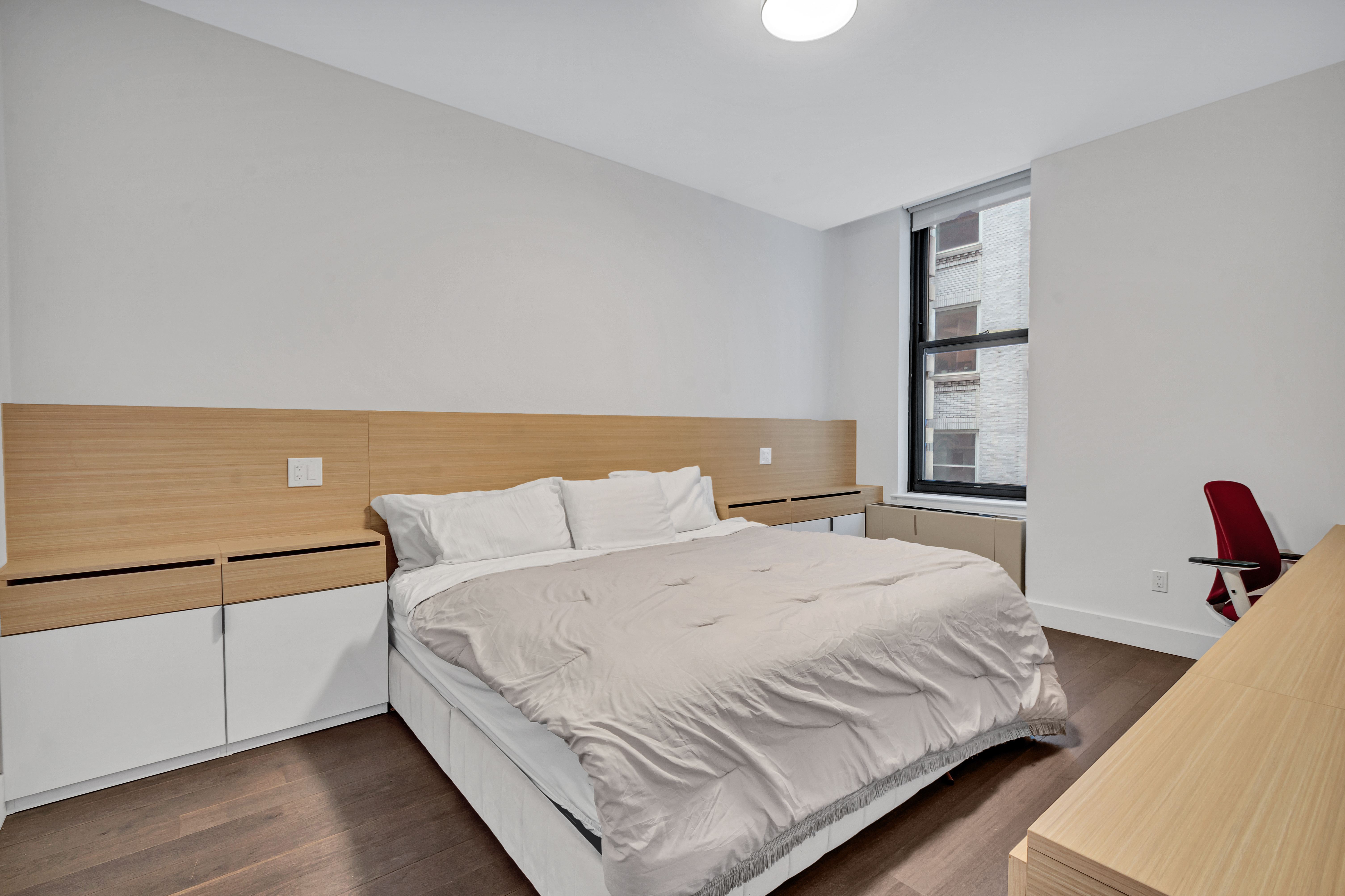 25 Broad Street, Unit 11K Manhattan, NY 10004 - Photo 5 of 16 a bedroom with a bed and a night stand