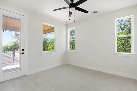 an empty room with windows and closet